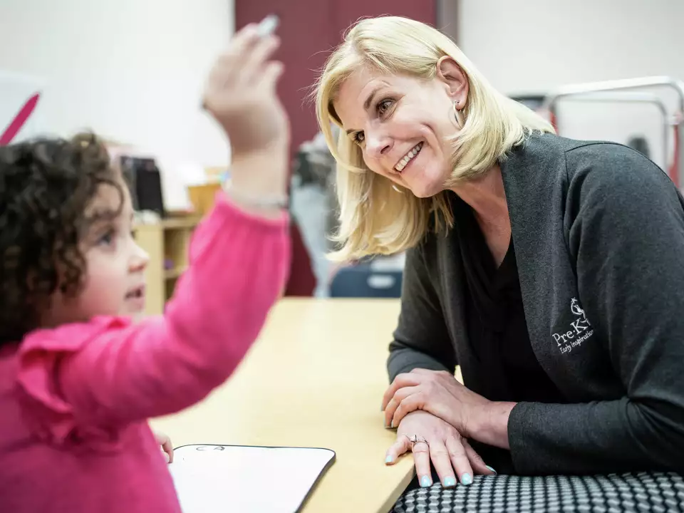 Sarah Baray talks to a child